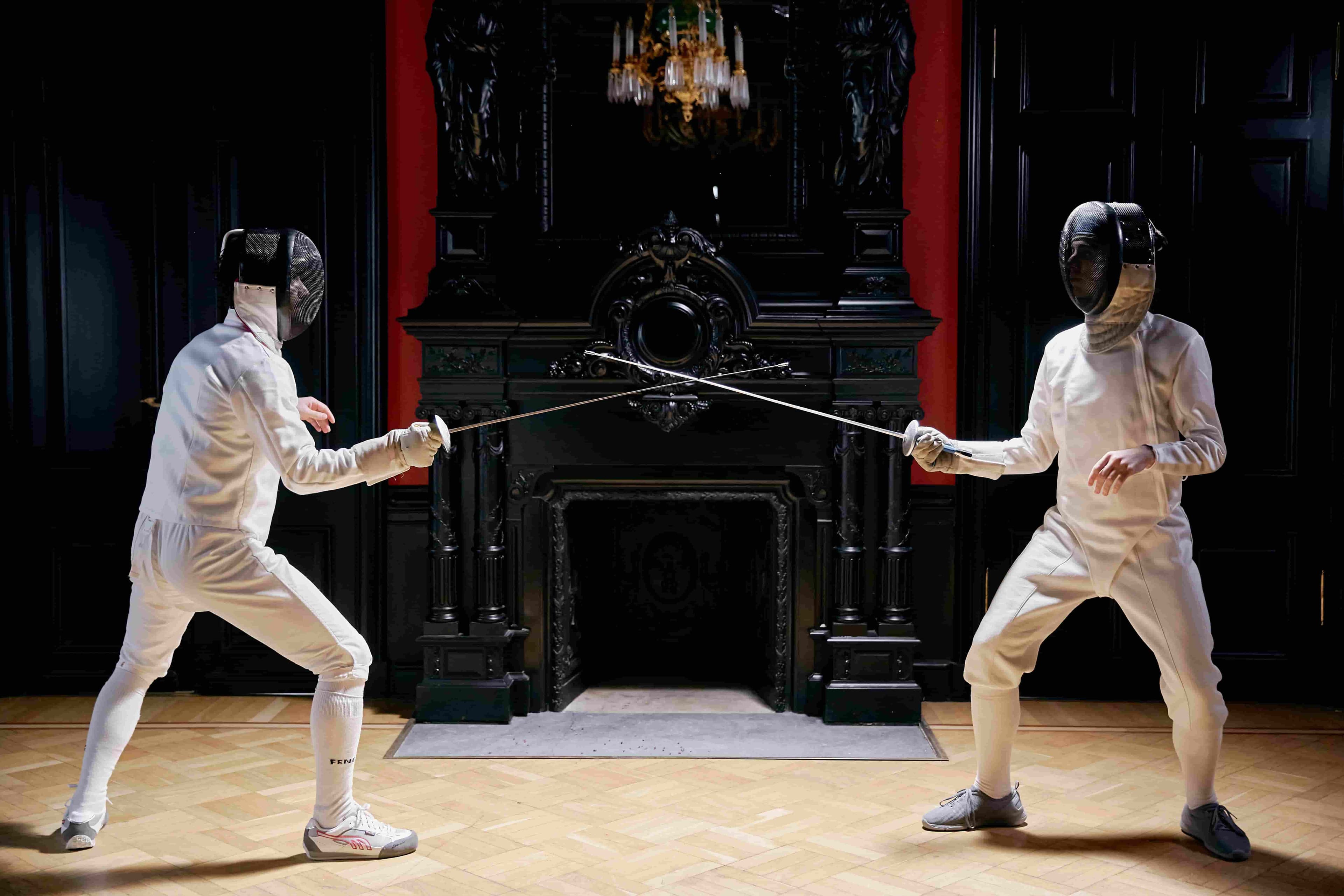 Two athletes fencing toghether