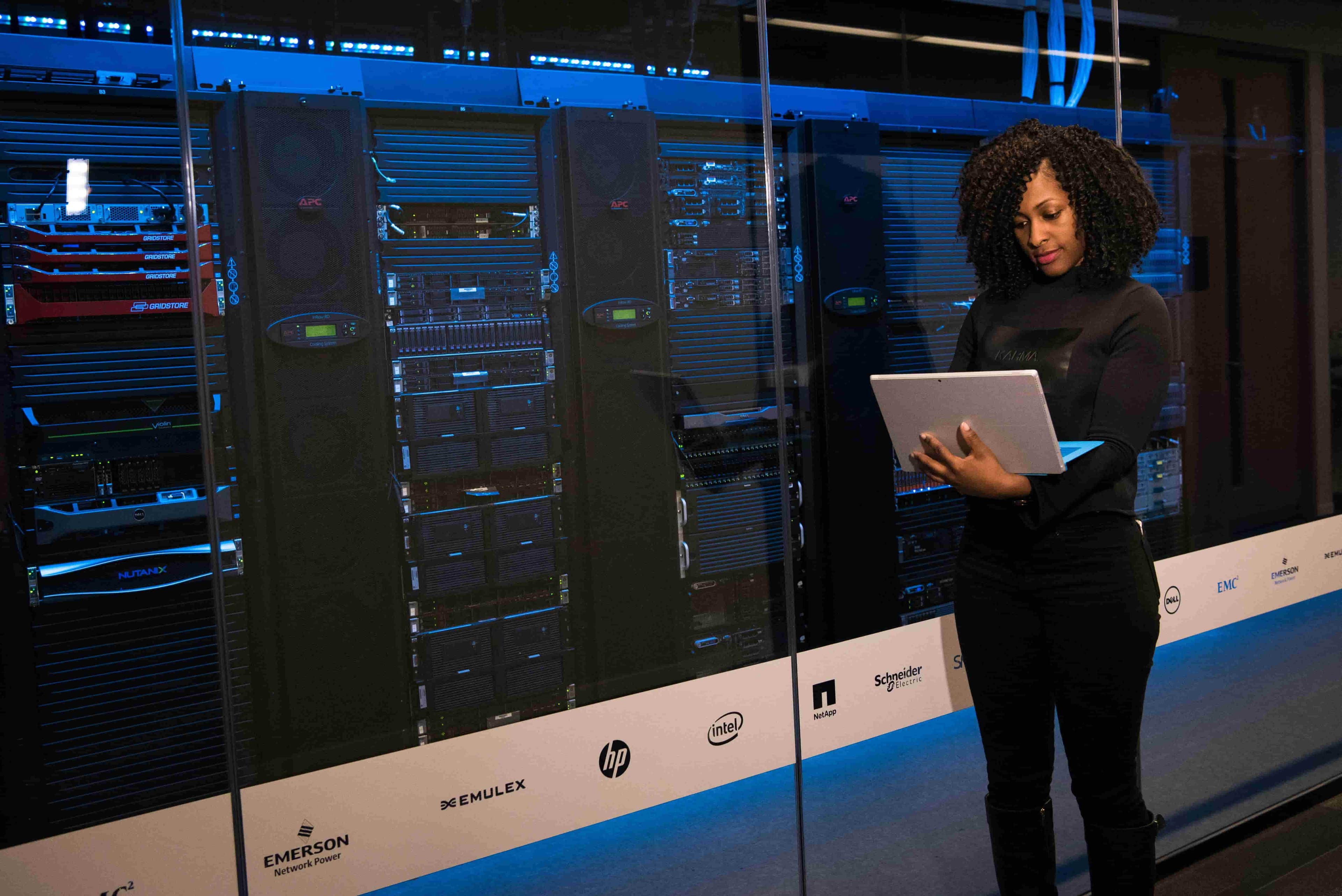 Woman working in front of a data center